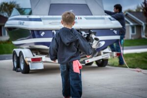 Boy repairing Mercruiser Sterndrive